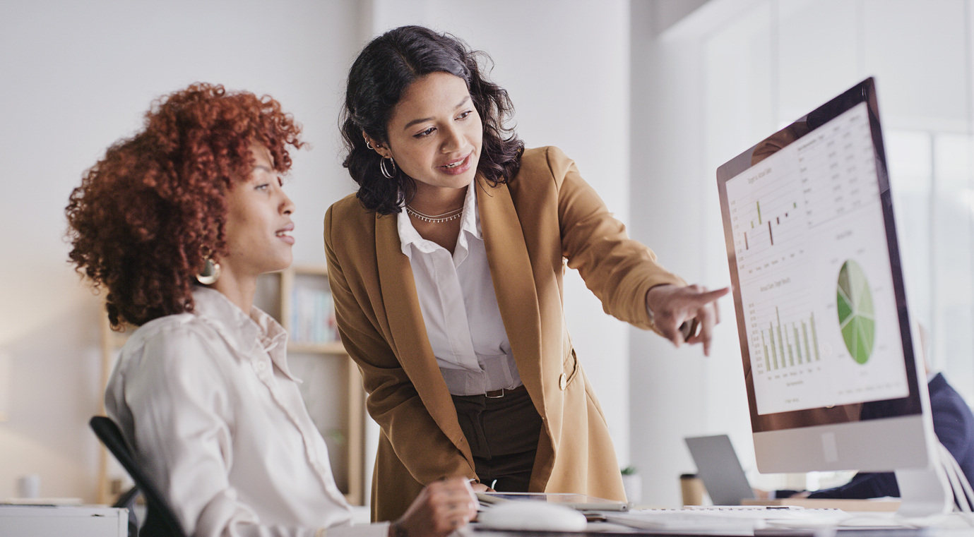 Women analyzing data on computer